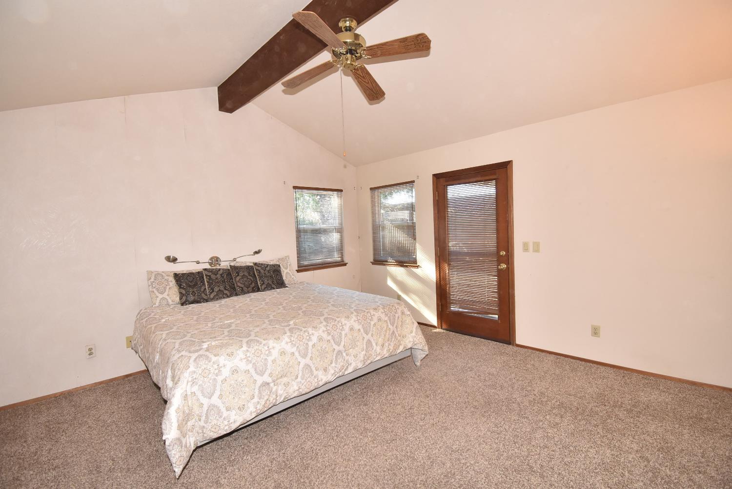 5316 Engle Road Carmichael, CA 95608 - Photo 25 of 47 a bedroom with a large bed and a chandelier fan