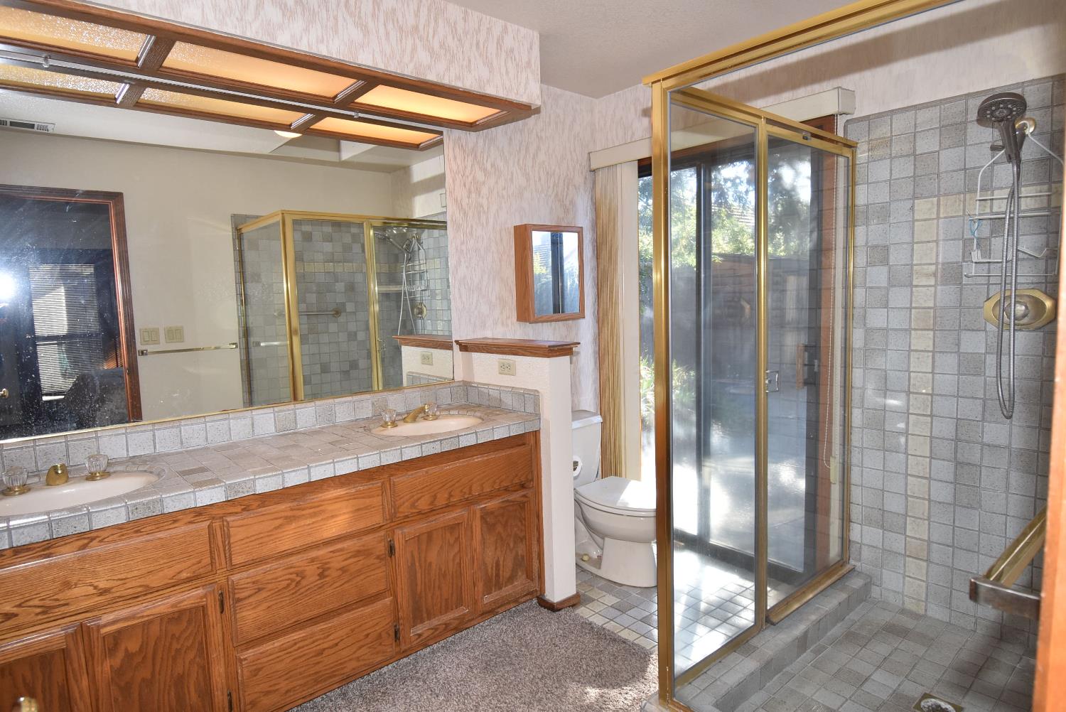 5316 Engle Road Carmichael, CA 95608 - Photo 29 of 47 a spacious bathroom with a granite countertop sink mirror and shower