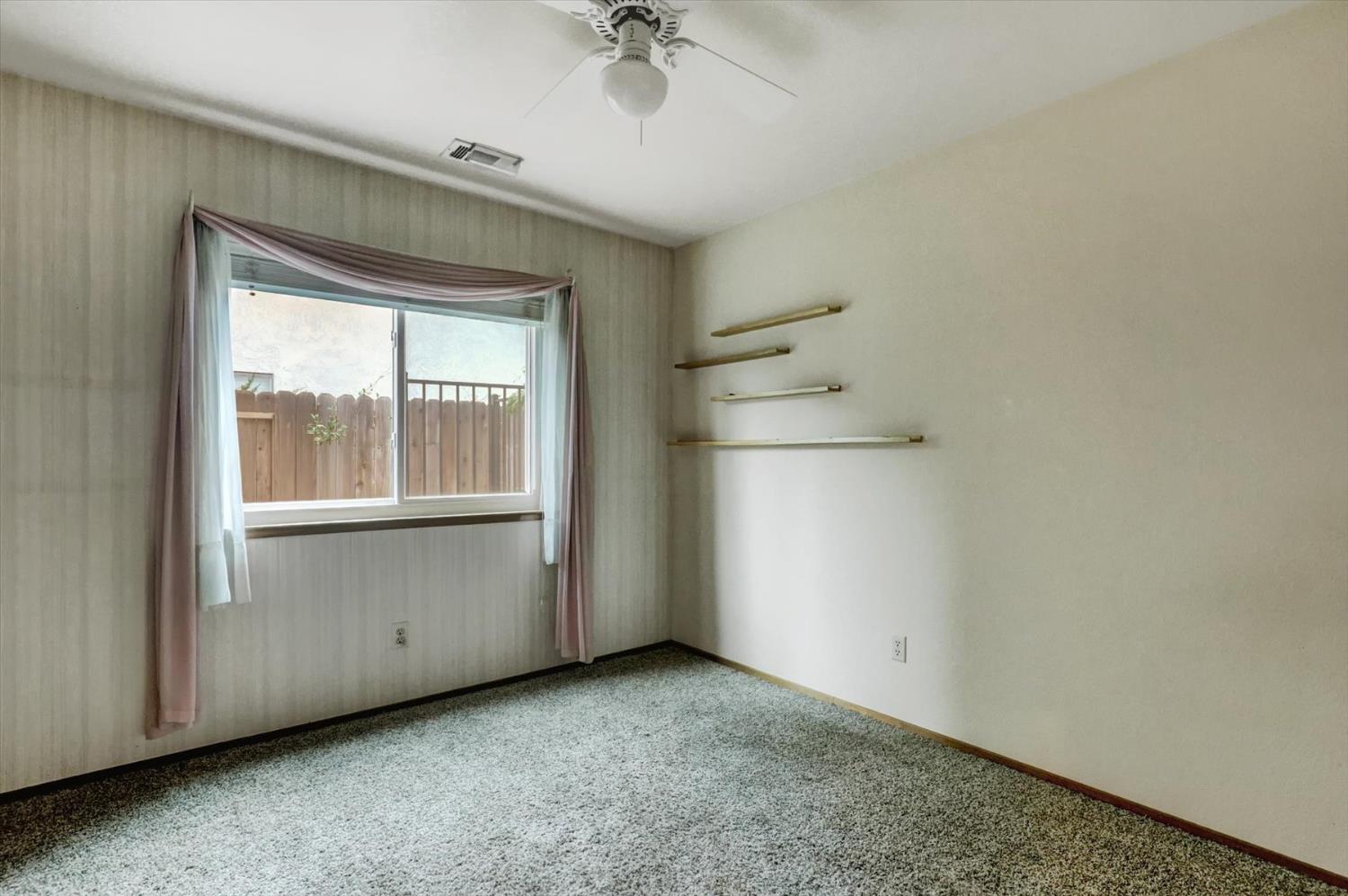 5316 Engle Road Carmichael, CA 95608 - Photo 40 of 47 an empty room with a window and a ceiling fan