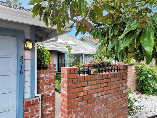 a view of a patio with table and chairs and potted plants