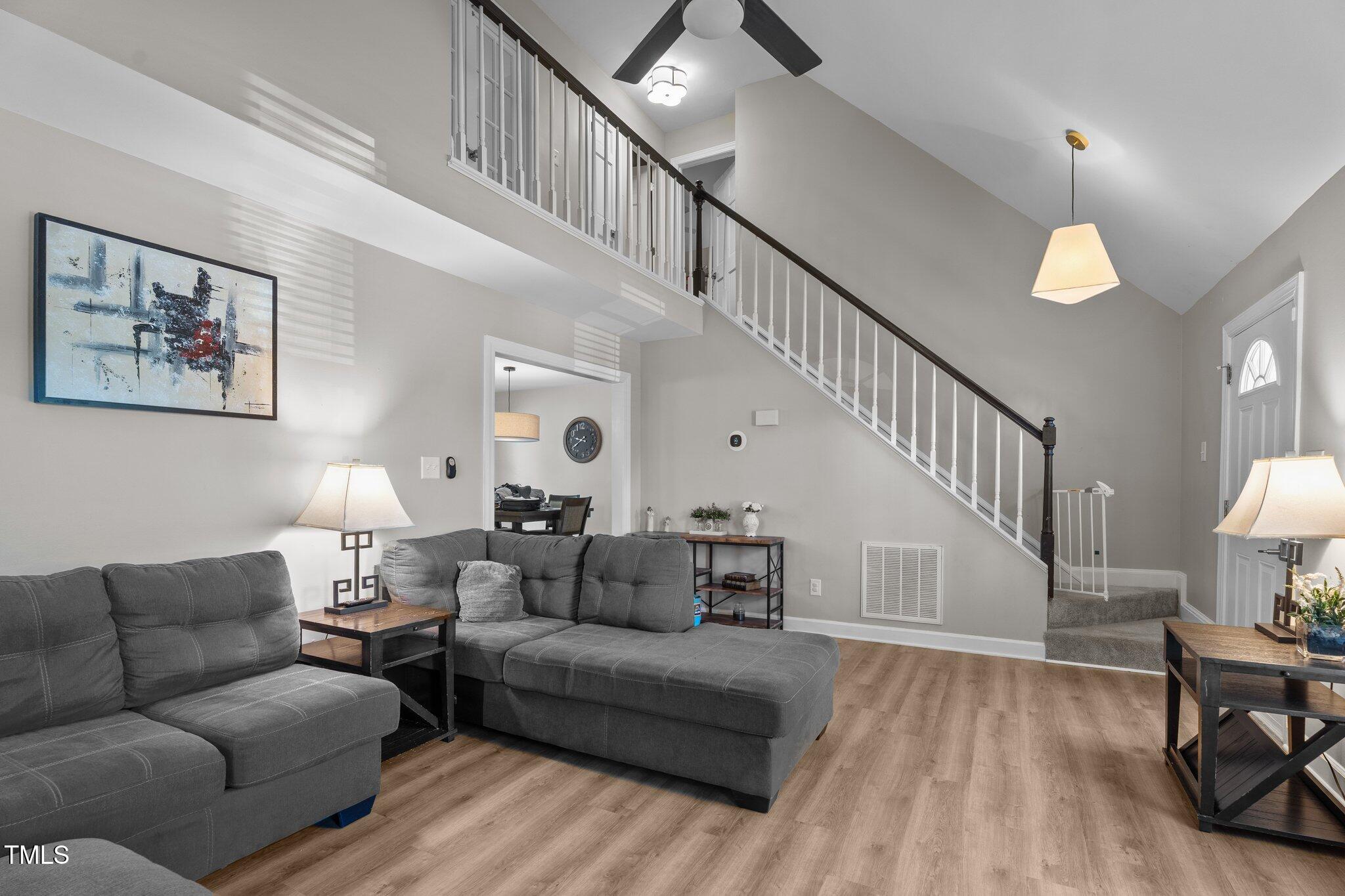 8333 Bellingham Circle Raleigh, NC 27615 - Photo 5 of 30 a living room with furniture and a wooden floor