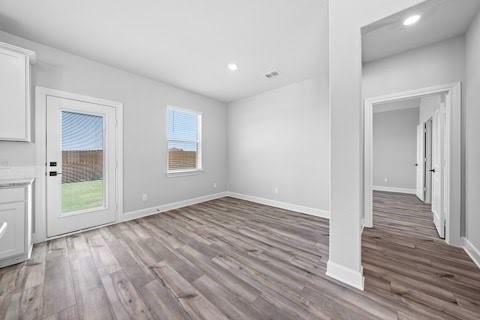 2004 Hardwick Drive Anna, TX 75409 - Photo 17 of 18 a view of an empty room with wooden floor and a window
