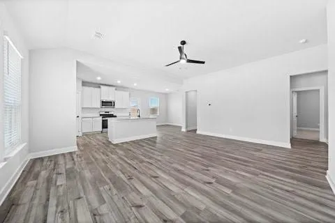 a view of kitchen with sink microwave and cabinets