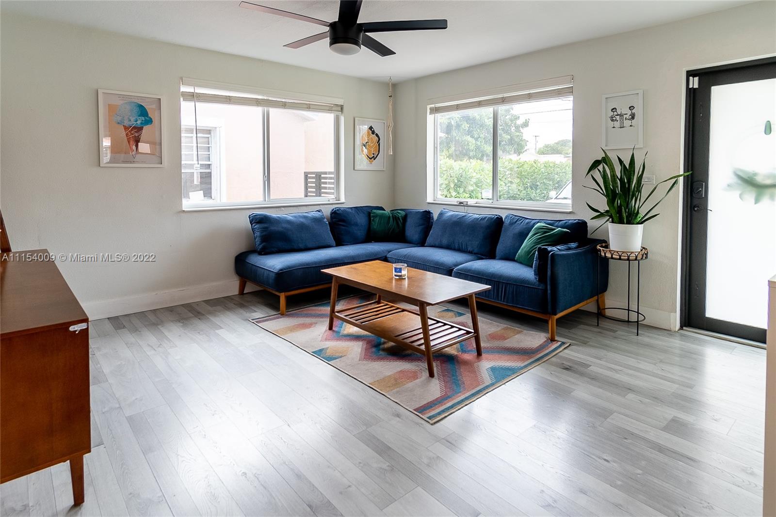 4235 East 9th Lane Hialeah, FL 33013 - Photo 16 of 34 a living room with furniture and a window