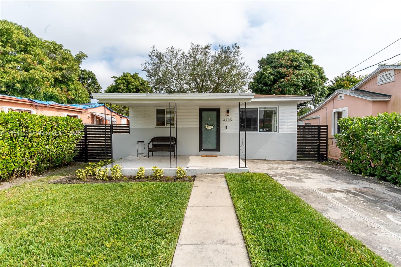 4235 East 9th Lane Hialeah, FL 33013 - Photo 2 of 34 a front view of a house with a garden and plants