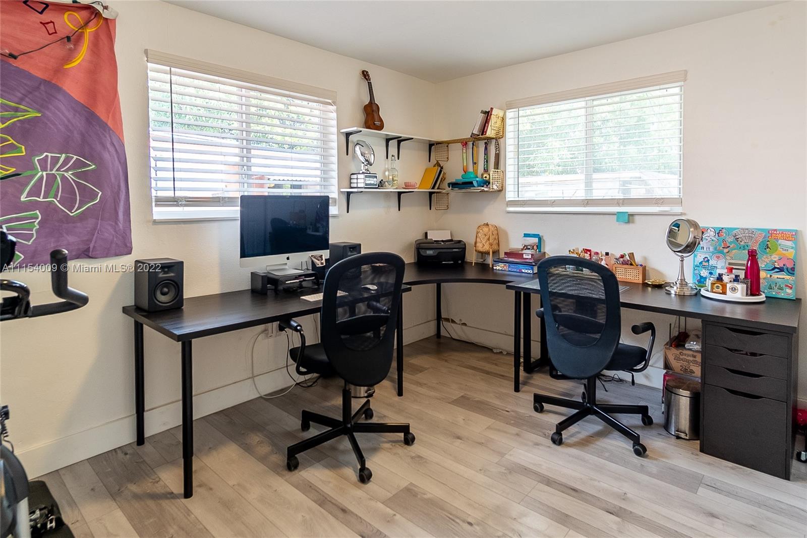 4235 East 9th Lane Hialeah, FL 33013 - Photo 22 of 34 a view of a workspace with furniture and a window