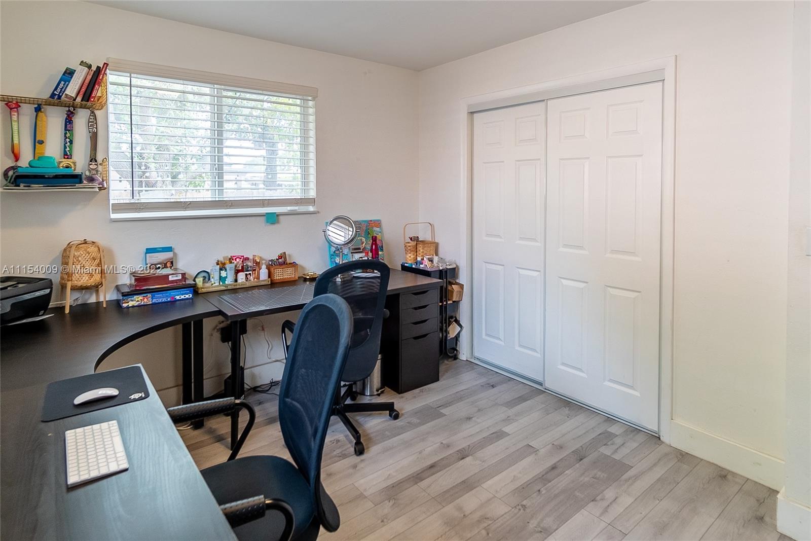 4235 East 9th Lane Hialeah, FL 33013 - Photo 23 of 34 a view of a workspace with furniture and a window
