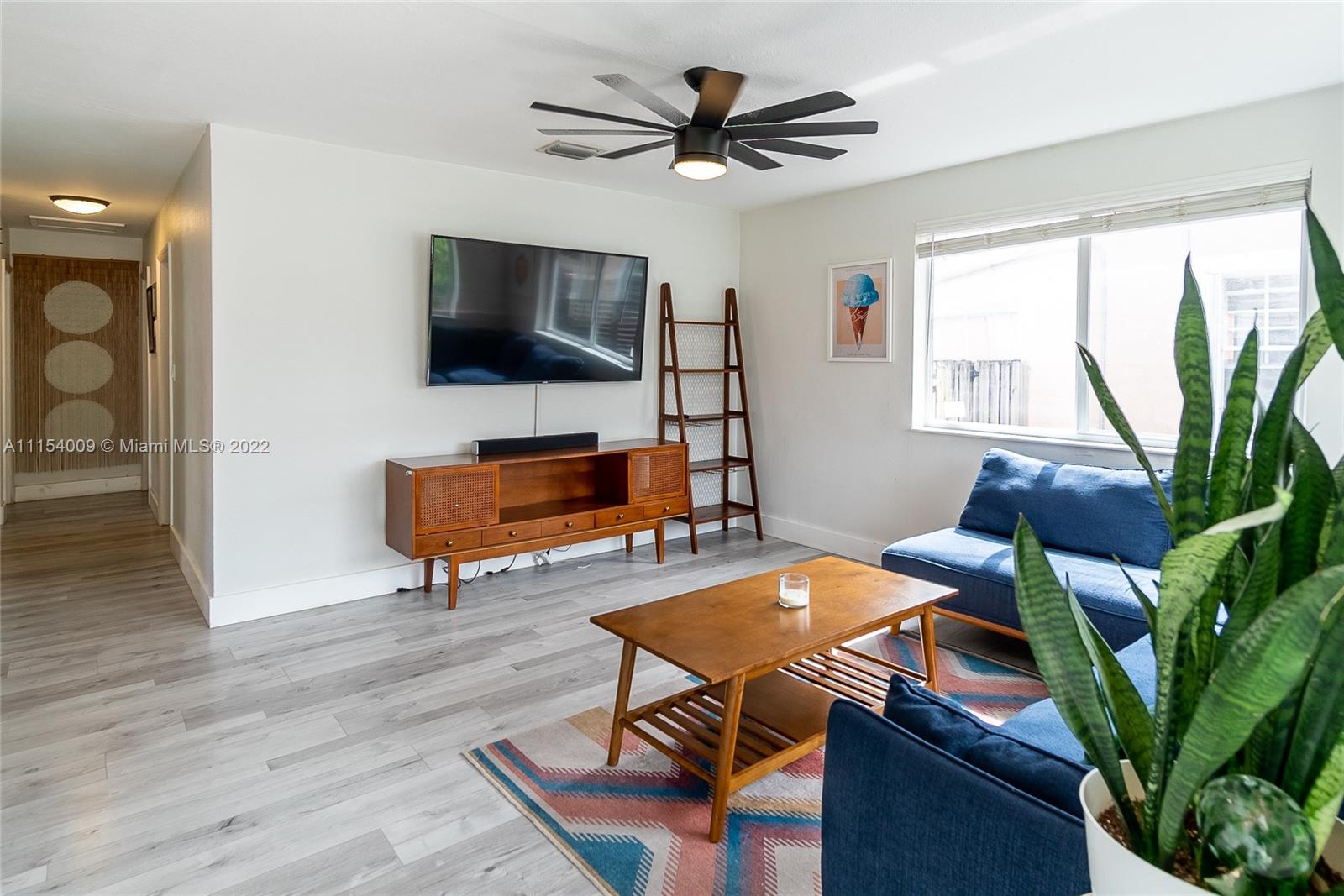 4235 East 9th Lane Hialeah, FL 33013 - Photo 3 of 34 a living room with furniture and a flat screen tv