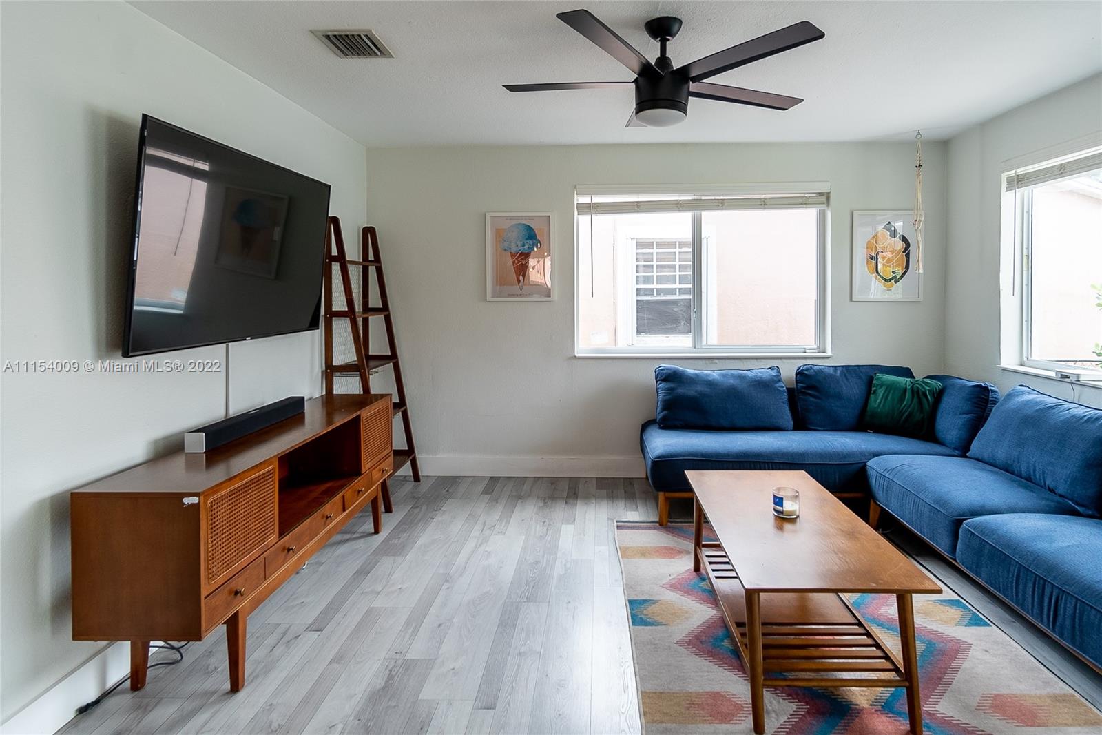4235 East 9th Lane Hialeah, FL 33013 - Photo 5 of 34 a living room with furniture and a flat screen tv