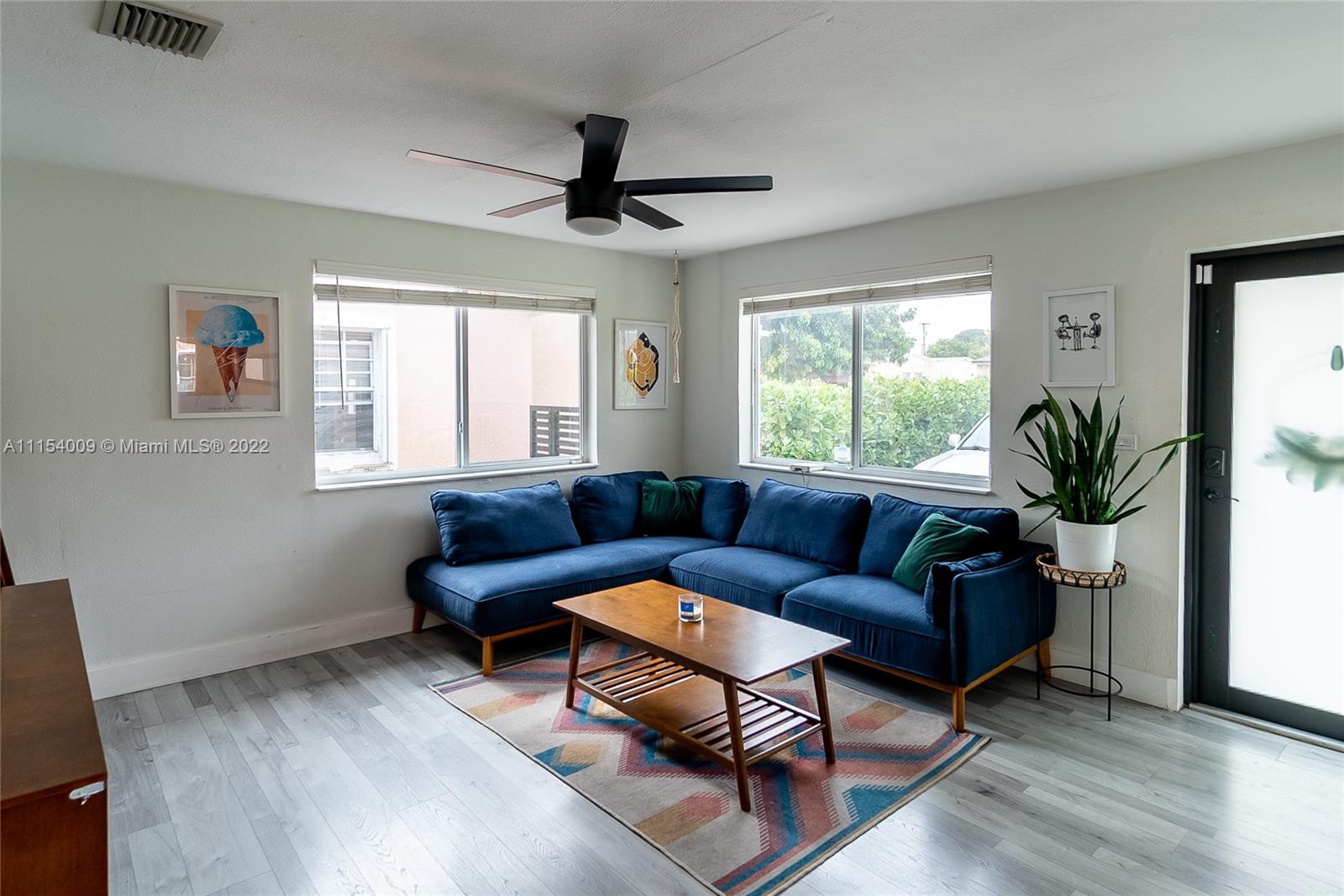 4235 East 9th Lane Hialeah, FL 33013 - Photo 6 of 34 a living room with furniture and a window