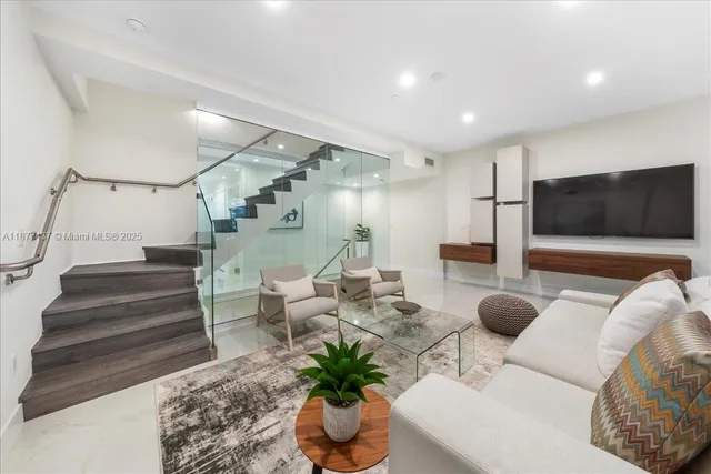 a living room with furniture and a flat screen tv
