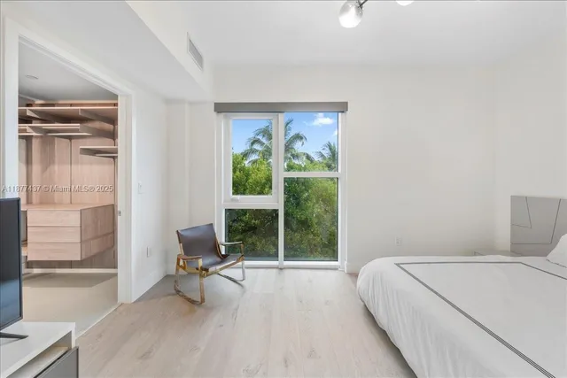 a view of a bedroom with a large window and bed