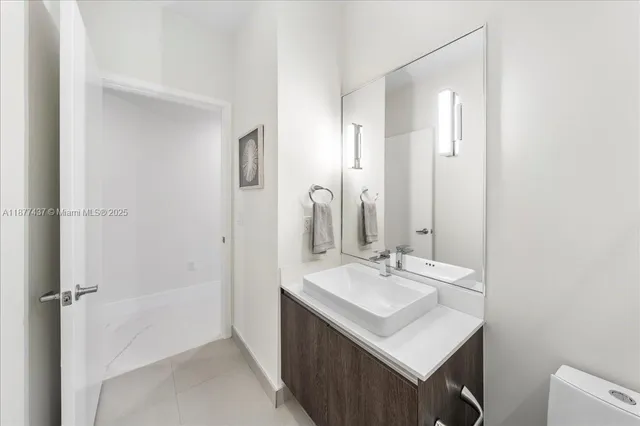 a bathroom with a sink a mirror and a shower