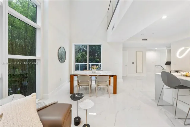 a living room with furniture a window and a table