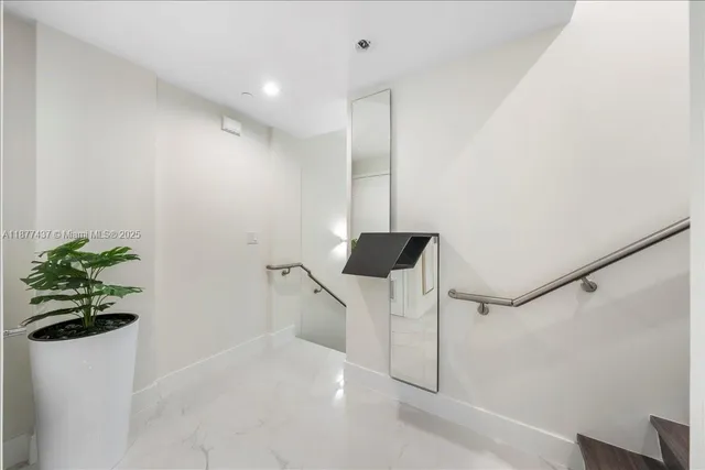 a bathroom with a shower and a plant in it