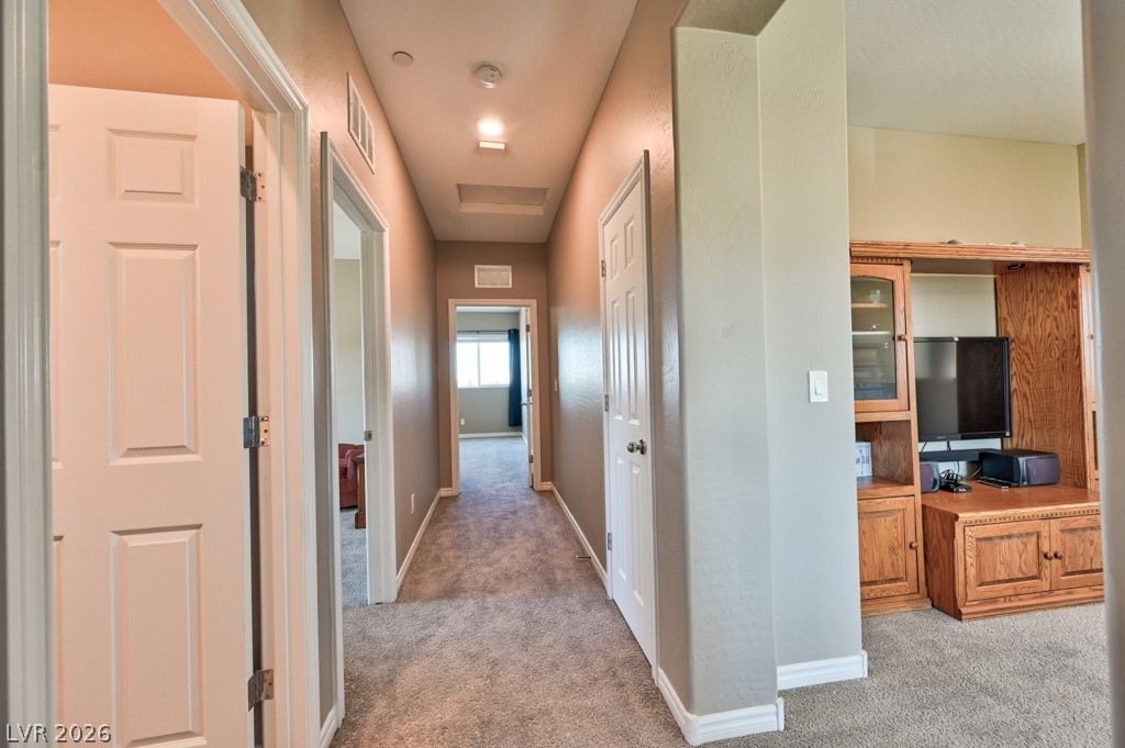 1054 Langston Ranch Avenue Henderson, NV 89002 - Photo 38 of 82 Hallway featuring light carpet and recessed LED lighting.