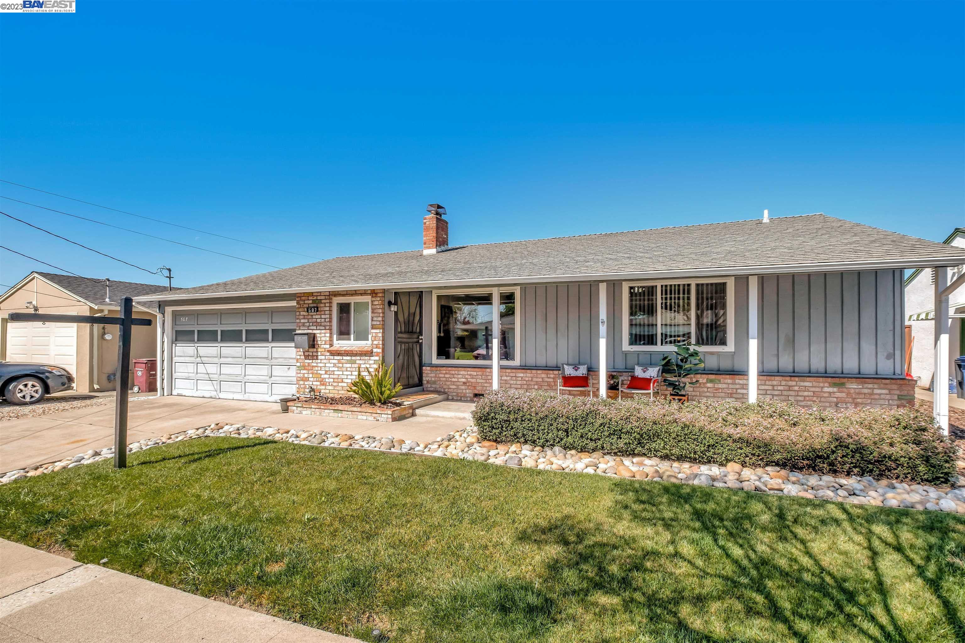 a front view of a house with a yard and porch