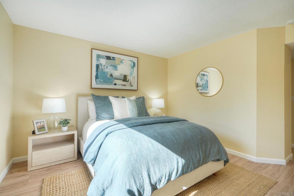 220 Shorehang Lane Encinitas, CA 92024 - Photo 14 of 27 a bedroom with a bed and painting on the wall