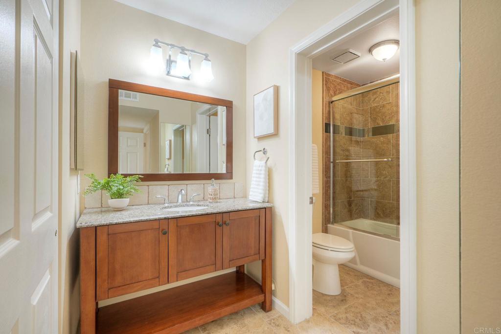 220 Shorehang Lane Encinitas, CA 92024 - Photo 15 of 27 a bathroom with a toilet a sink and mirror