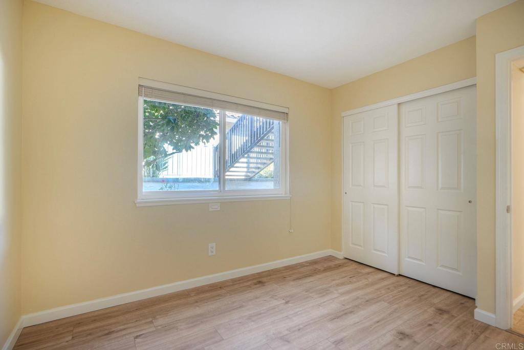 220 Shorehang Lane Encinitas, CA 92024 - Photo 16 of 27 an empty room with wooden floor and windows