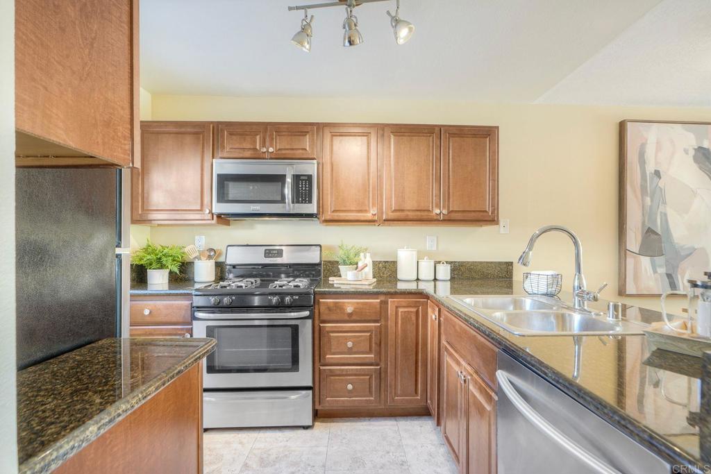 220 Shorehang Lane Encinitas, CA 92024 - Photo 5 of 27 a kitchen with stainless steel appliances granite countertop a stove a sink and a microwave