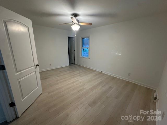 5052 Suwarrow Court Fort Mill, SC 29708 - Photo 7 of 9 an empty room with staircase and mirror