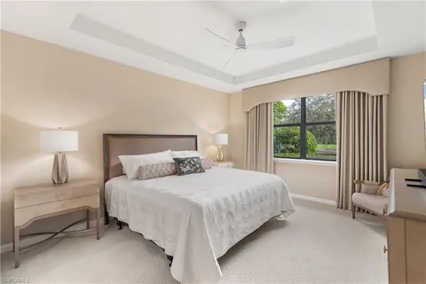 a bedroom with a bed and a lamp