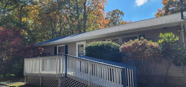 a view of a house with a flower garden