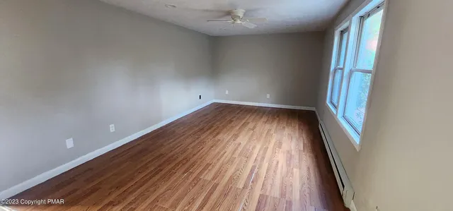 wooden floor in an empty room with a window