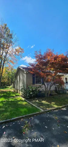a view of a big house with a big yard