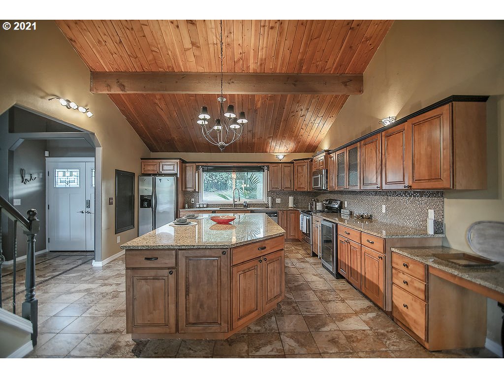 265 Curtis Hill Road Chehalis, WA 98532 - Photo 7 of 32 a kitchen with kitchen island granite countertop a sink cabinets and stainless steel appliances