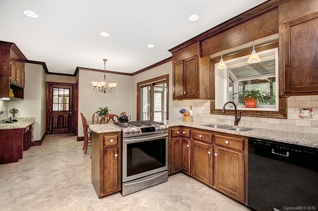 2733 High Ridge Road, Unit 15 Charlotte, NC 28270 - Photo 7 of 24 a kitchen with stainless steel appliances granite countertop a stove and a sink