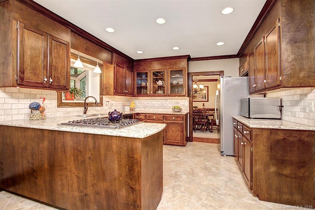 2733 High Ridge Road, Unit 15 Charlotte, NC 28270 - Photo 8 of 24 a kitchen with stainless steel appliances granite countertop a sink stove and refrigerator