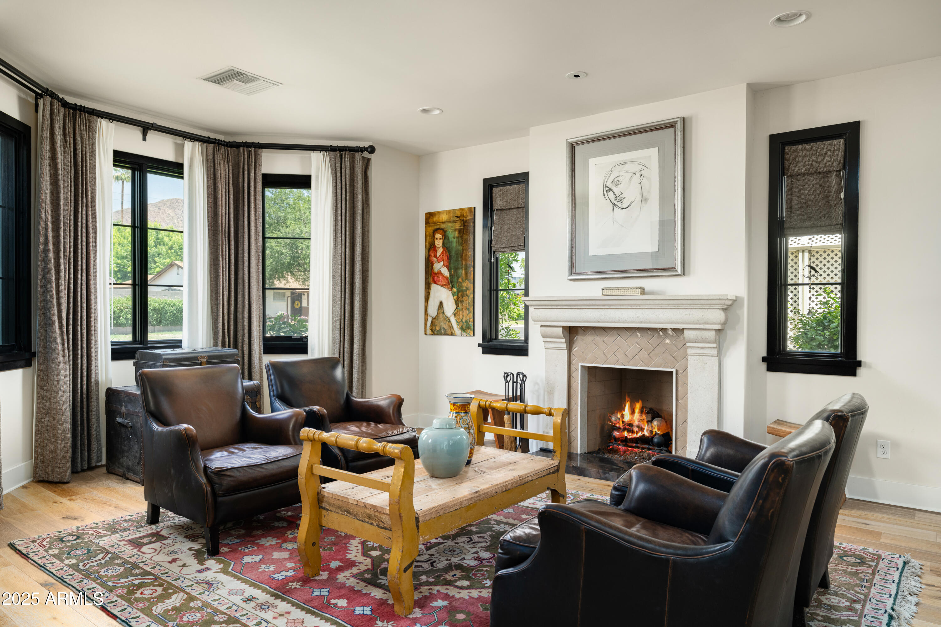 4901 East Amelia Avenue Phoenix, AZ 85018 - Photo 19 of 38 a living room with furniture and a fireplace