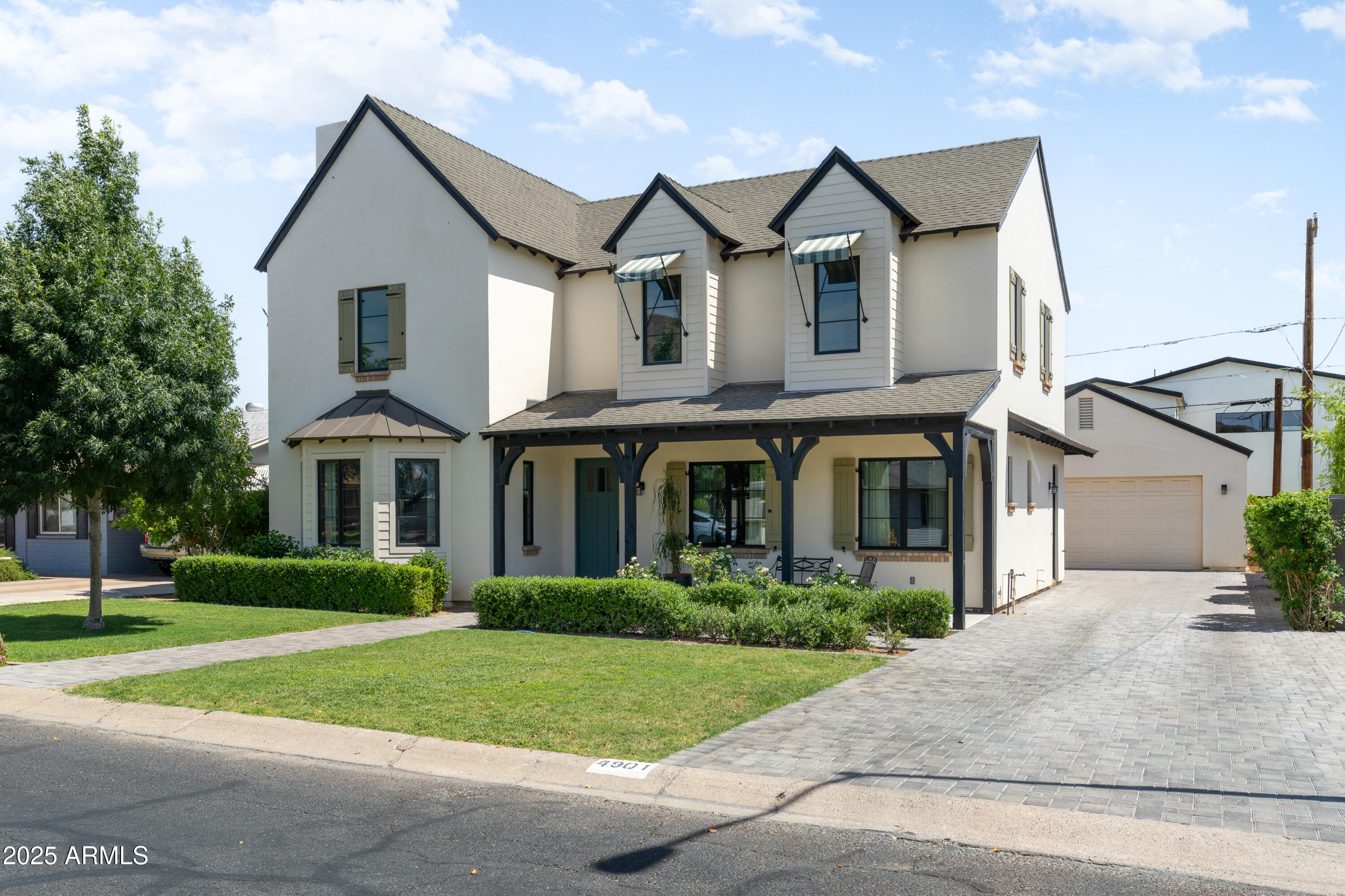 4901 East Amelia Avenue Phoenix, AZ 85018 - Photo 2 of 38 a front view of a house with a yard and trees