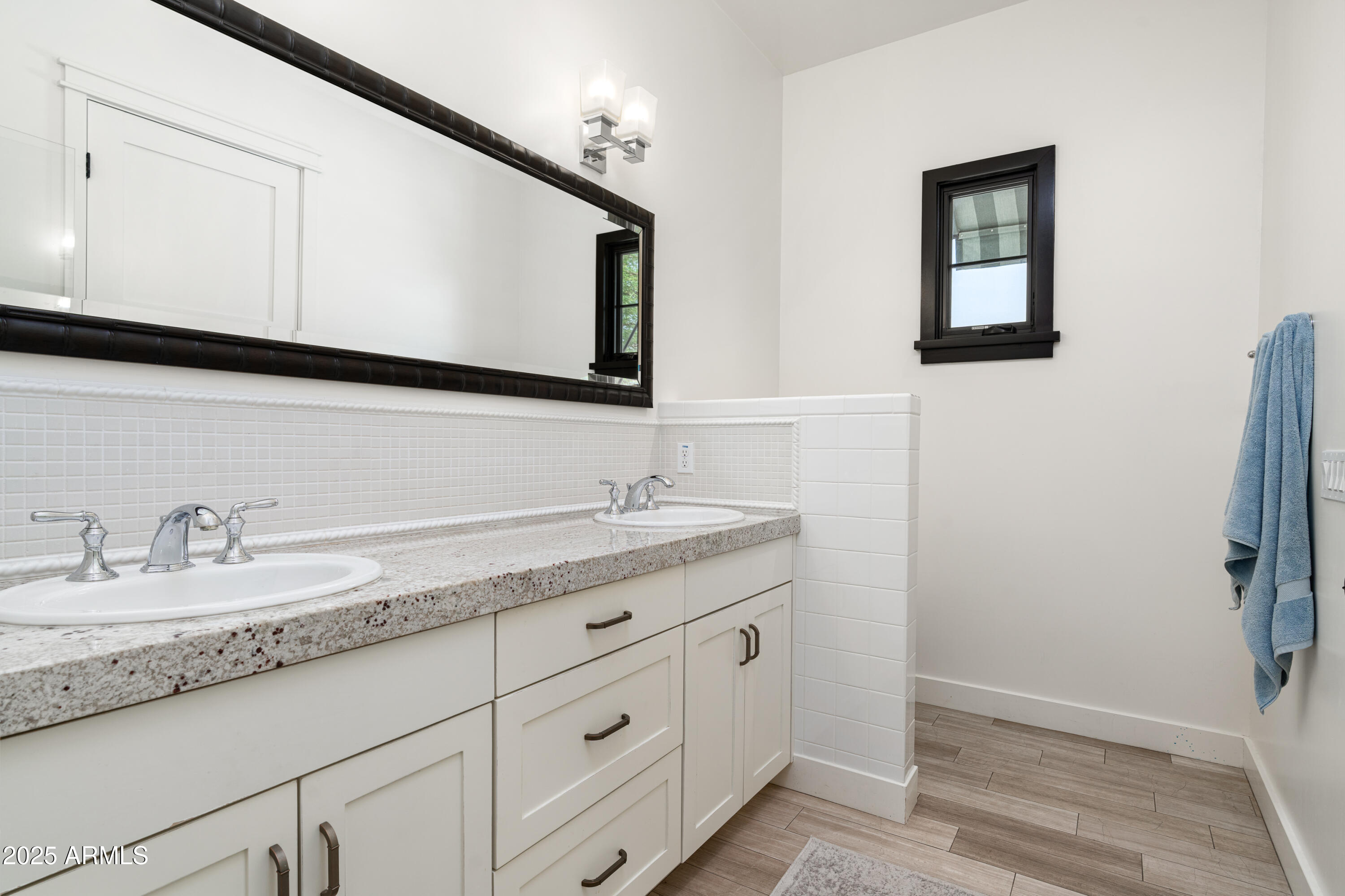 4901 East Amelia Avenue Phoenix, AZ 85018 - Photo 25 of 38 a bathroom with double sink and a mirror