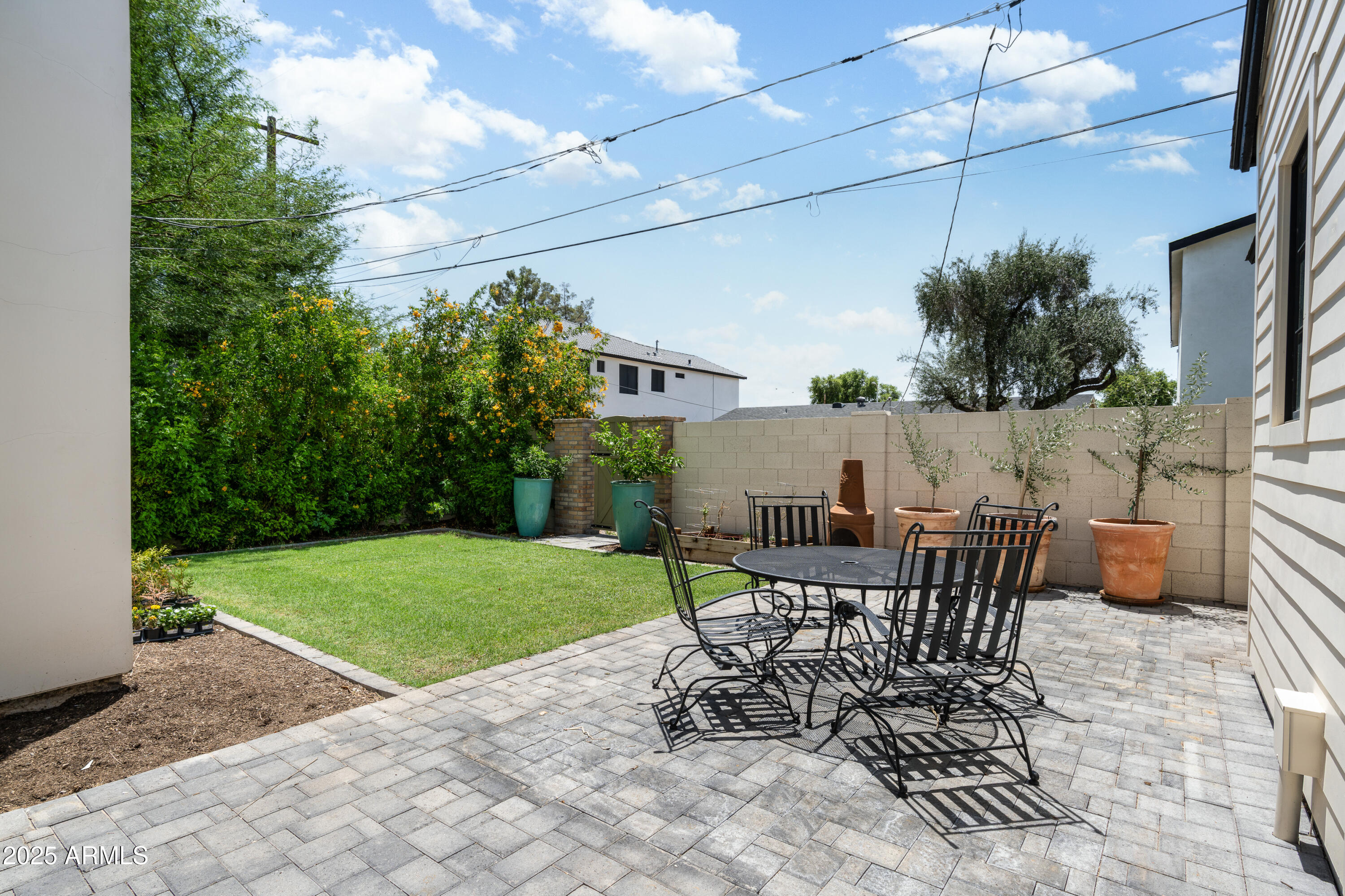 4901 East Amelia Avenue Phoenix, AZ 85018 - Photo 32 of 38 a view of a patio with a table and chairs