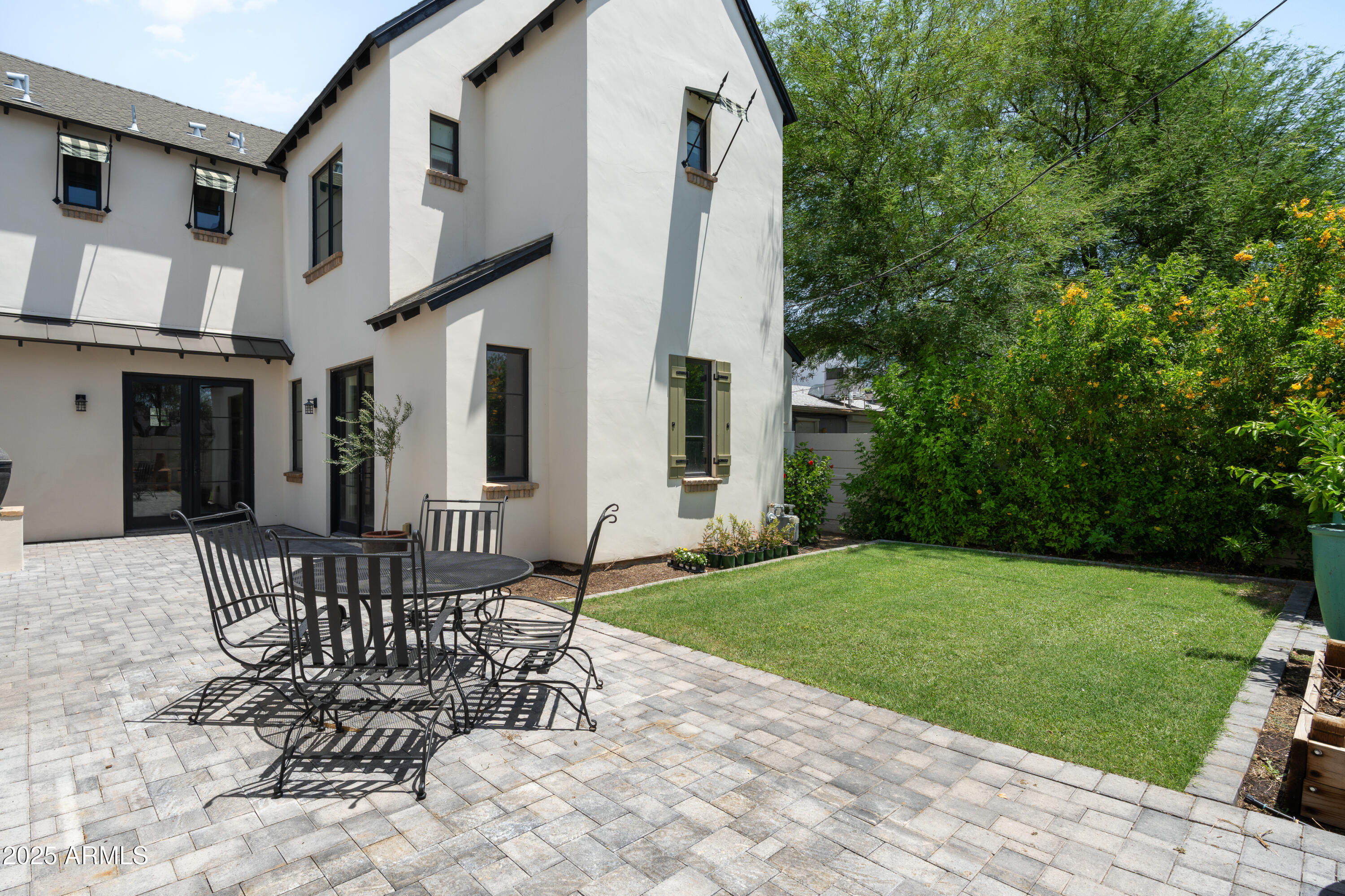 4901 East Amelia Avenue Phoenix, AZ 85018 - Photo 33 of 38 a view of a patio with a table and chairs