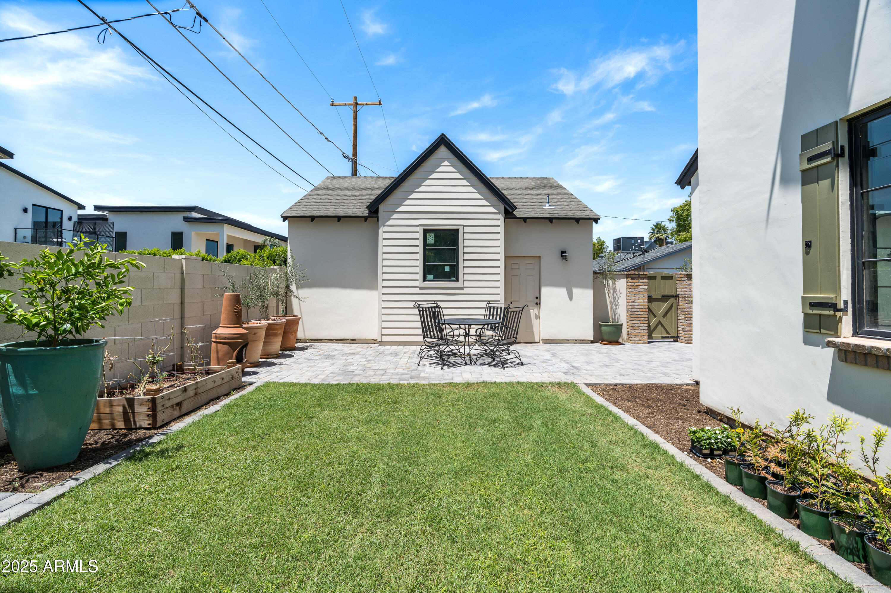 4901 East Amelia Avenue Phoenix, AZ 85018 - Photo 35 of 38 a front view of house with a garden and patio
