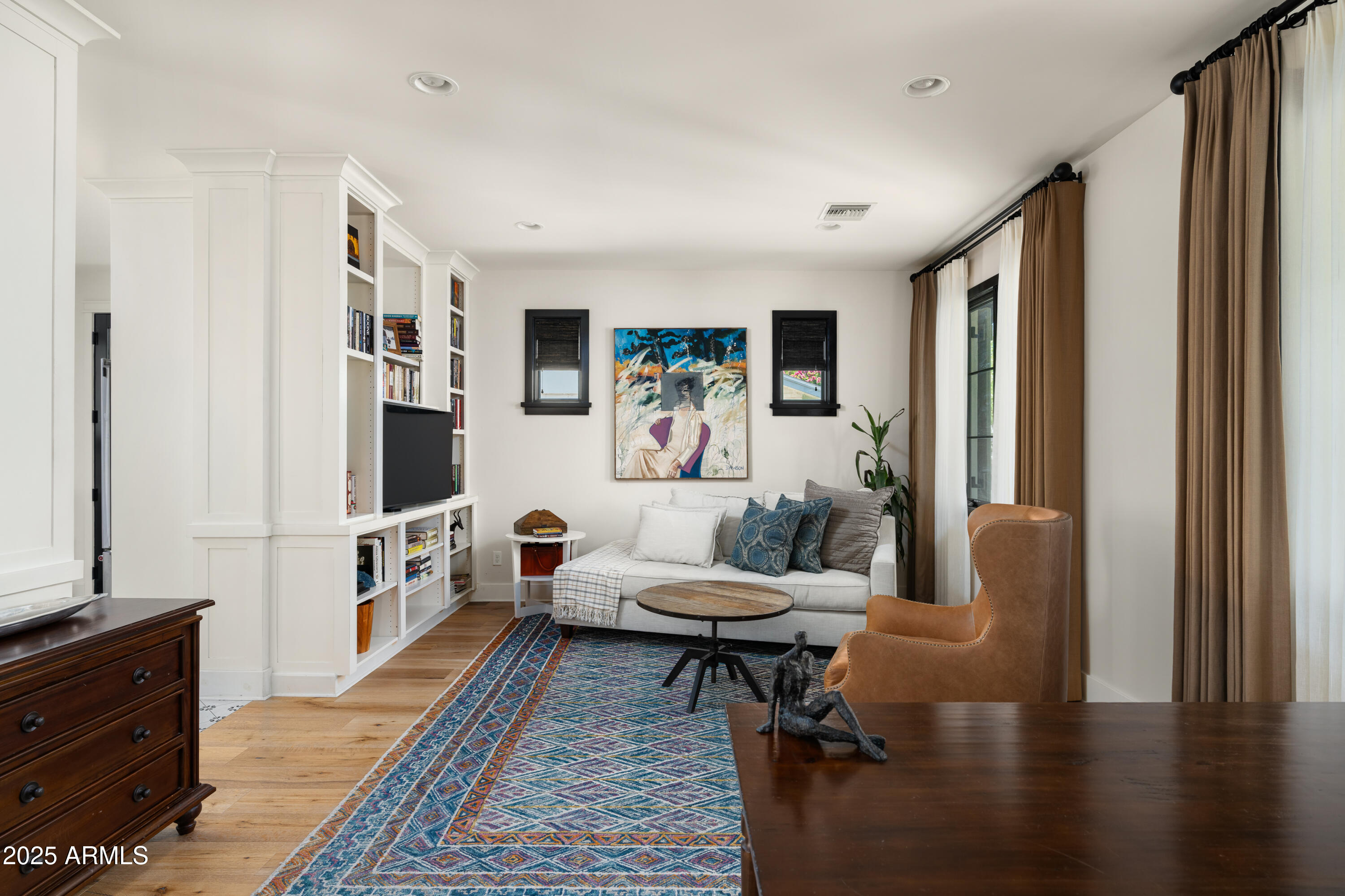 4901 East Amelia Avenue Phoenix, AZ 85018 - Photo 8 of 38 a living room with furniture and a flat screen tv