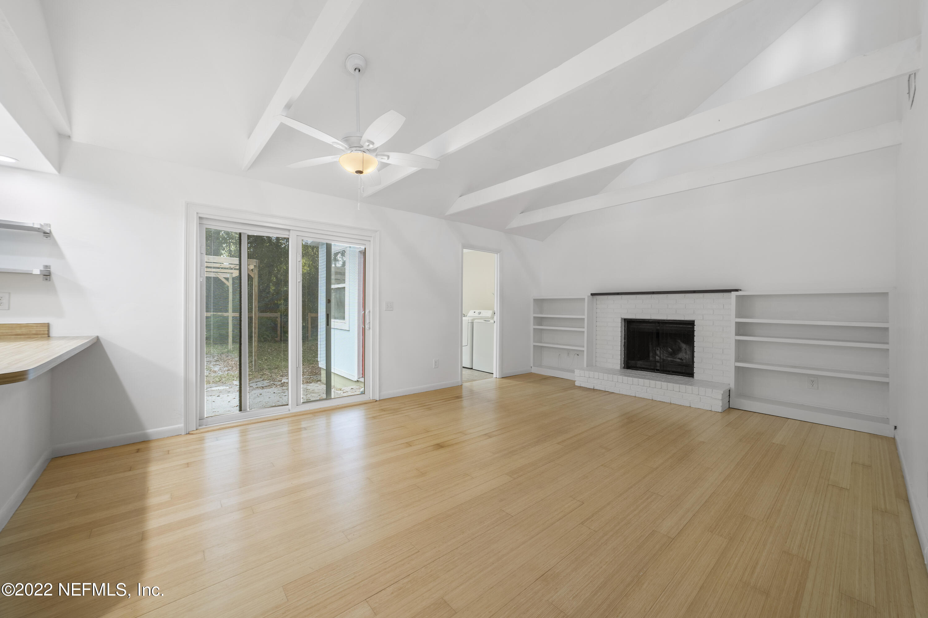914 Prince Road St. Augustine, FL 32086 - Photo 14 of 26 an empty room with windows and fireplace