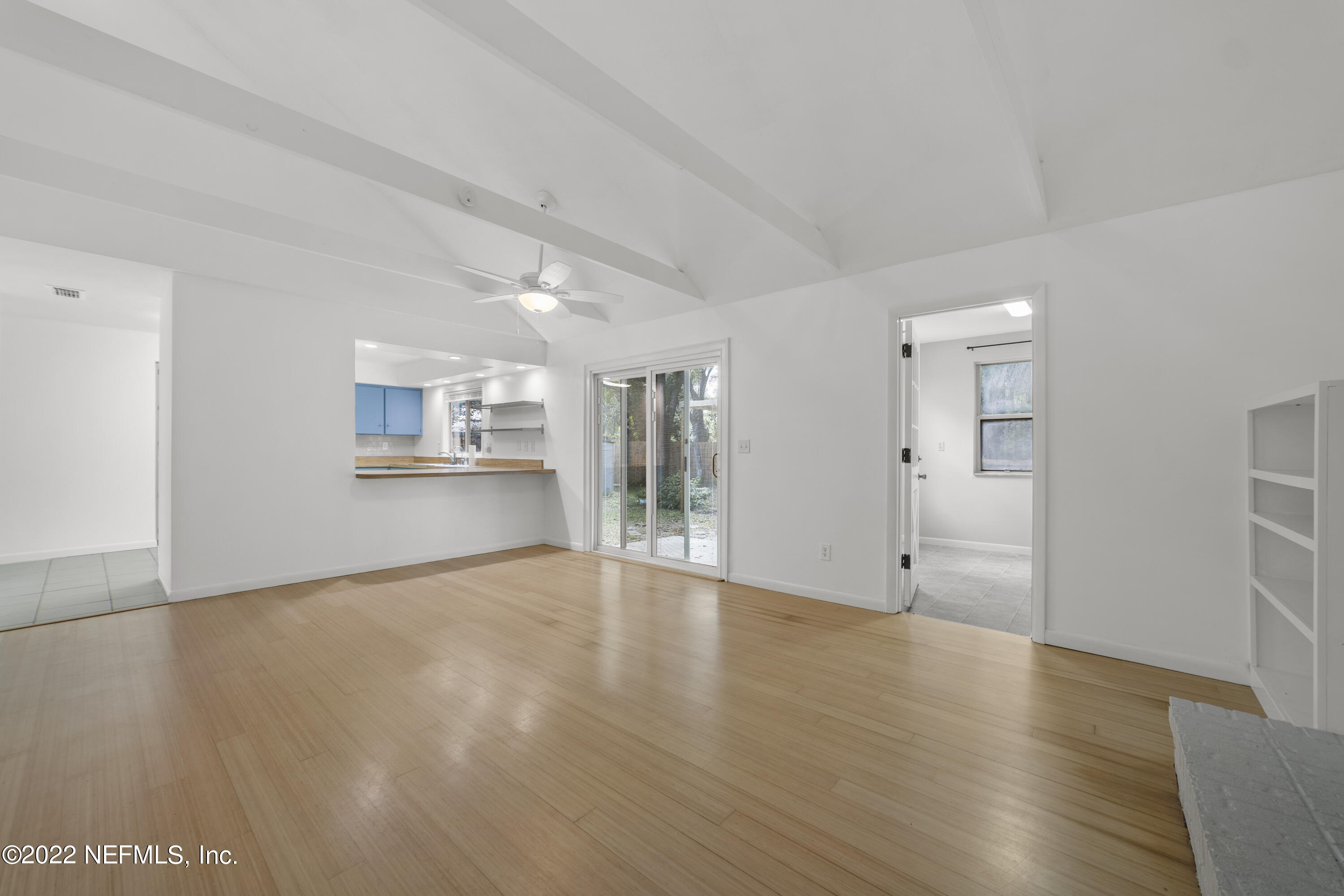 914 Prince Road St. Augustine, FL 32086 - Photo 16 of 26 a view of an empty room with wooden floor and a window