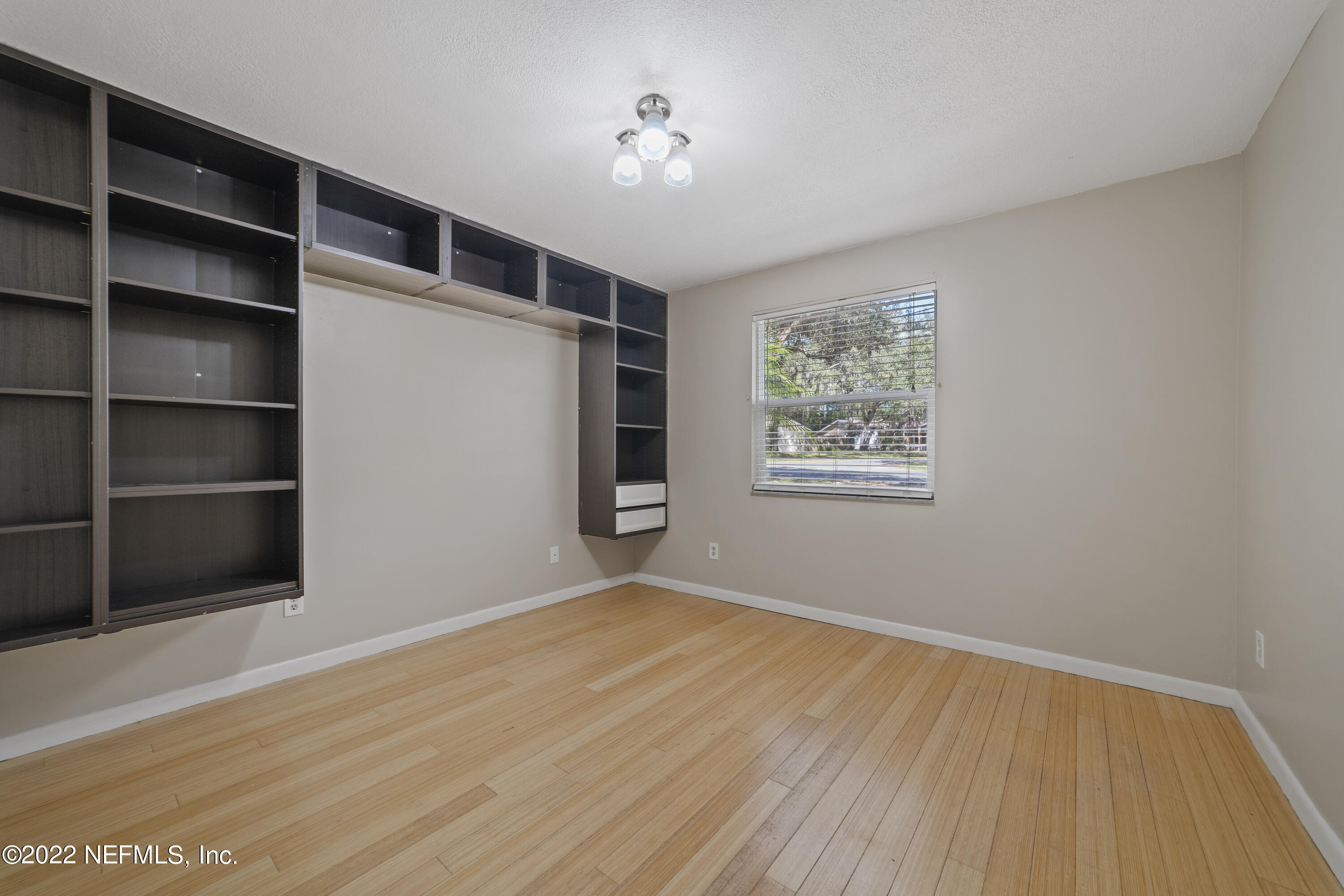 914 Prince Road St. Augustine, FL 32086 - Photo 22 of 26 a view of an empty room with a window and wooden floor