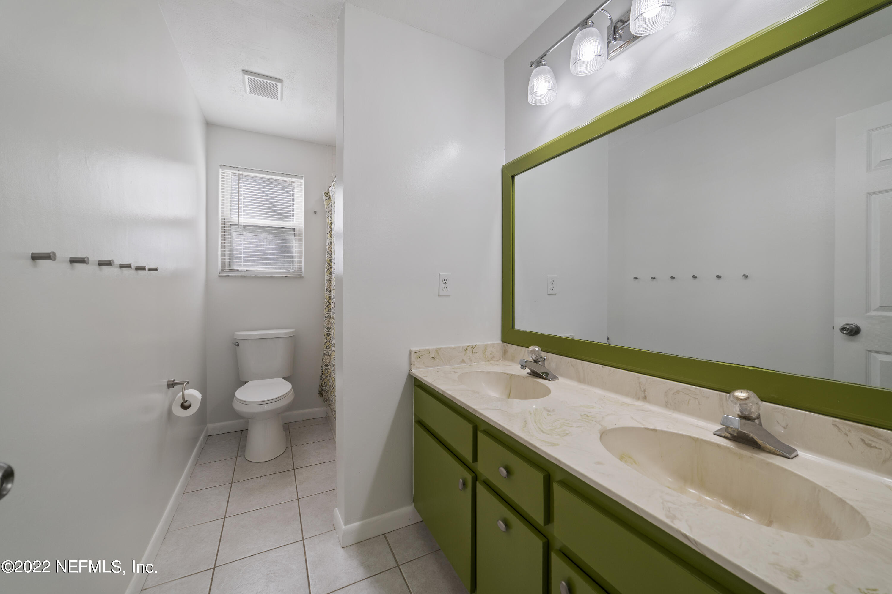 914 Prince Road St. Augustine, FL 32086 - Photo 25 of 26 a bathroom with a sink a toilet and mirror