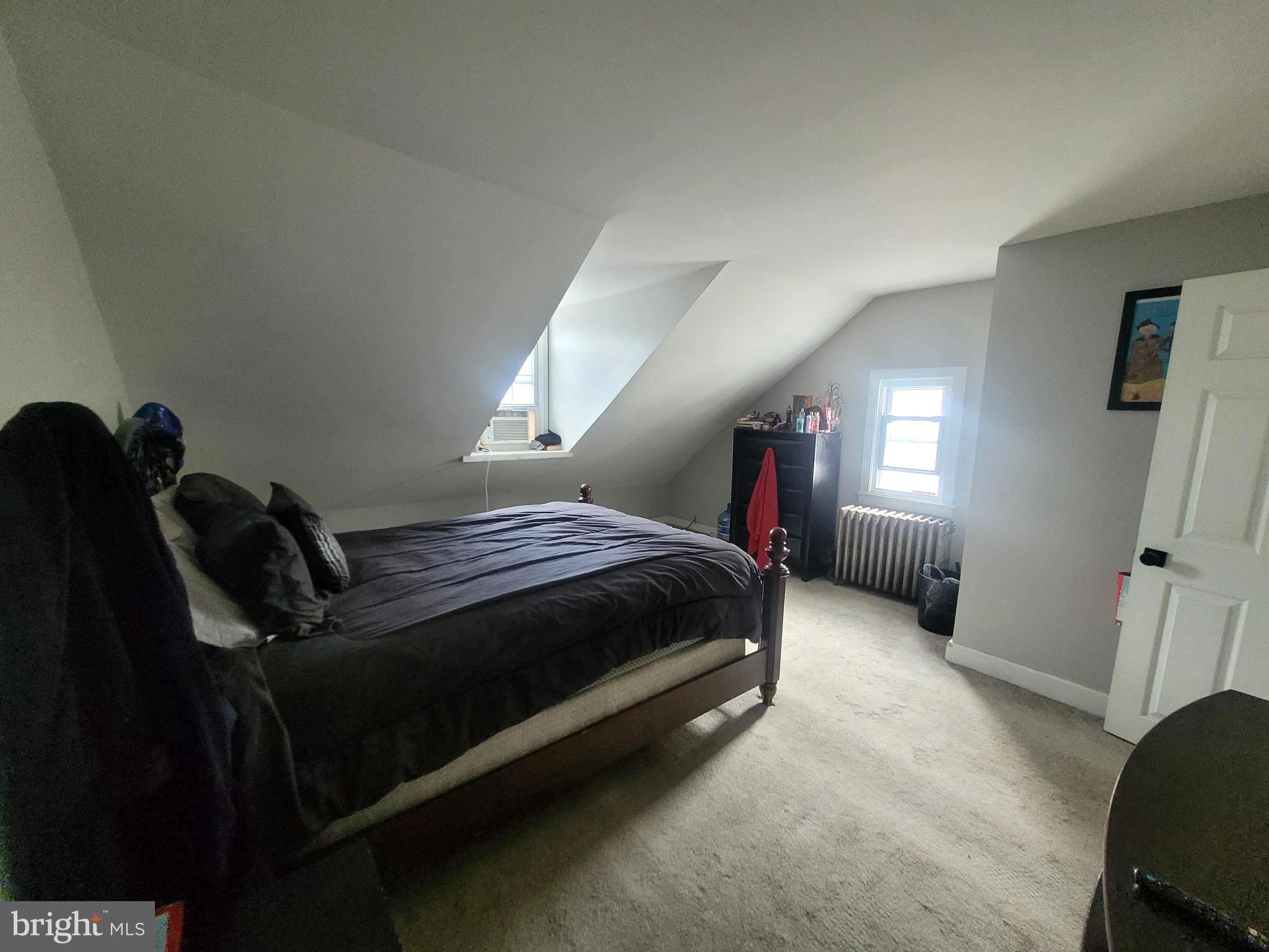 574 Bath Street Bristol, PA 19007 - Photo 17 of 23 a spacious bedroom with a bed and a mirror