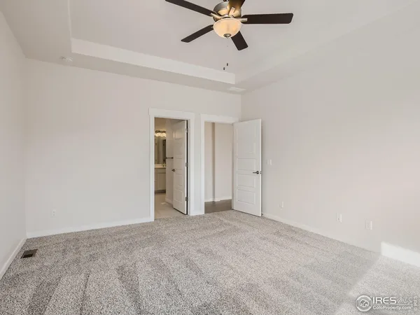 a view of a big room with a ceiling fan