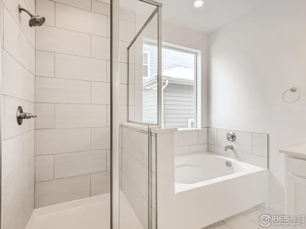 a white bath tub sitting next to a white sink