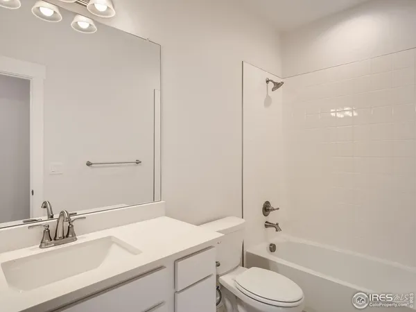 a bathroom with a sink toilet vanity and shower