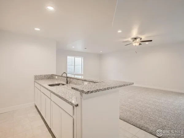 a bathroom with a granite countertop sink and a granite