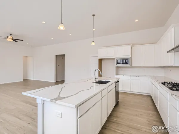 a kitchen with a stove sink and cabinets